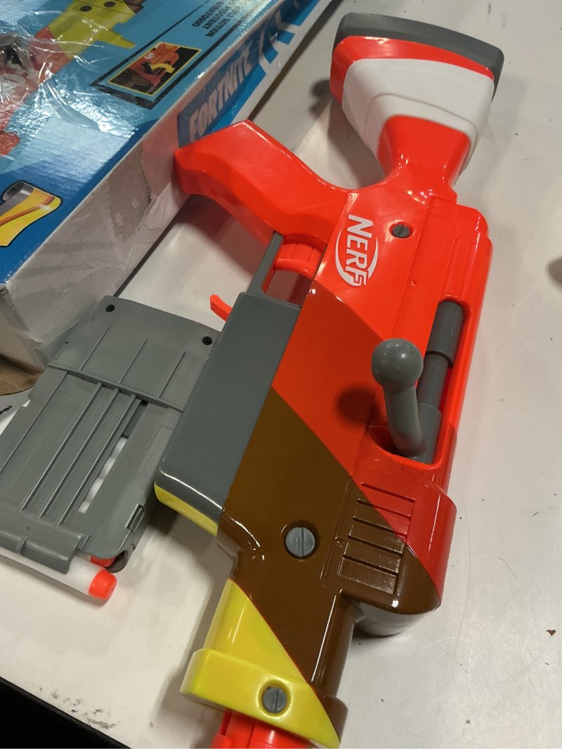 Condition photo showing As Is for nerf fortnite hr dart blaster, ruff wrap design, 6-dart elite clip, 6 nerf elite darts, rotating bolt action, detachable barrel