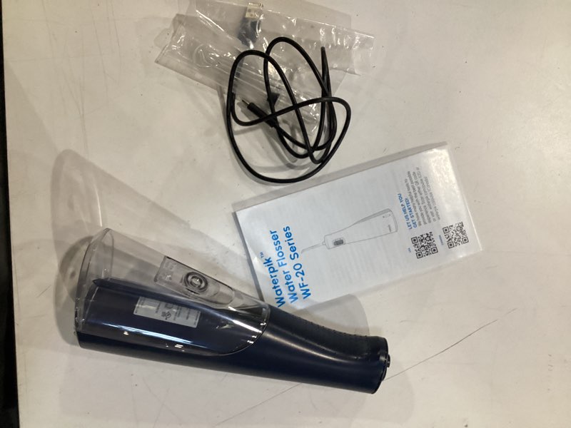 Condition photo showing Good Condition for waterpik cordless pulse rechargeable portable water flosser for teeth, gums, braces care and travel with 2 flossing tips, waterproof for shower, ada accepted, wf-20 blue, packaging and tips may vary