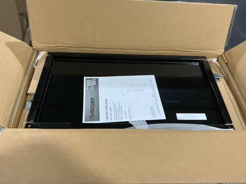 Condition photo showing New/Like New for ready-to-assemble 24-gauge 1-shelf steel wall mounted garage cabinet in black (28 in. w x 29.7 in. h x 12 in. d)