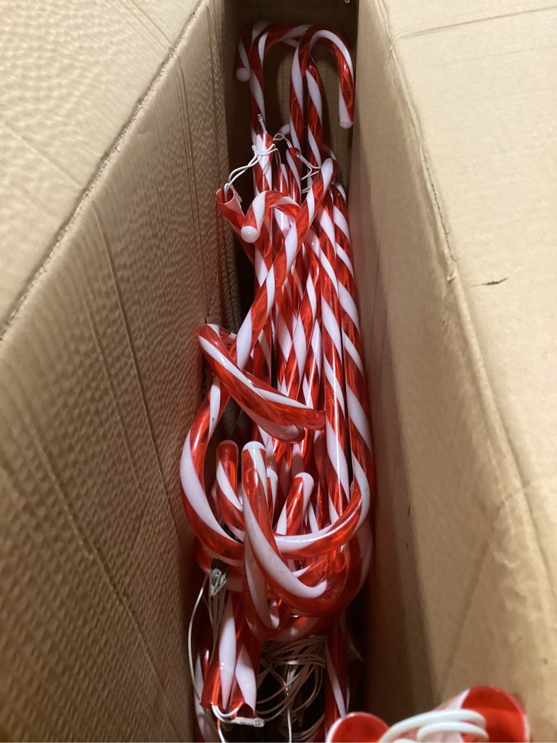 Condition photo showing As Is for COOLWUFAN 24 Pack Christmas Candy Cane Pathway Lights, 22'' Outdoor Christmas Decorations Path Lights, Waterproof Candy Cane Yard Markers for Walkway, Lawn, Patio, Holiday Landscape Path Décor
