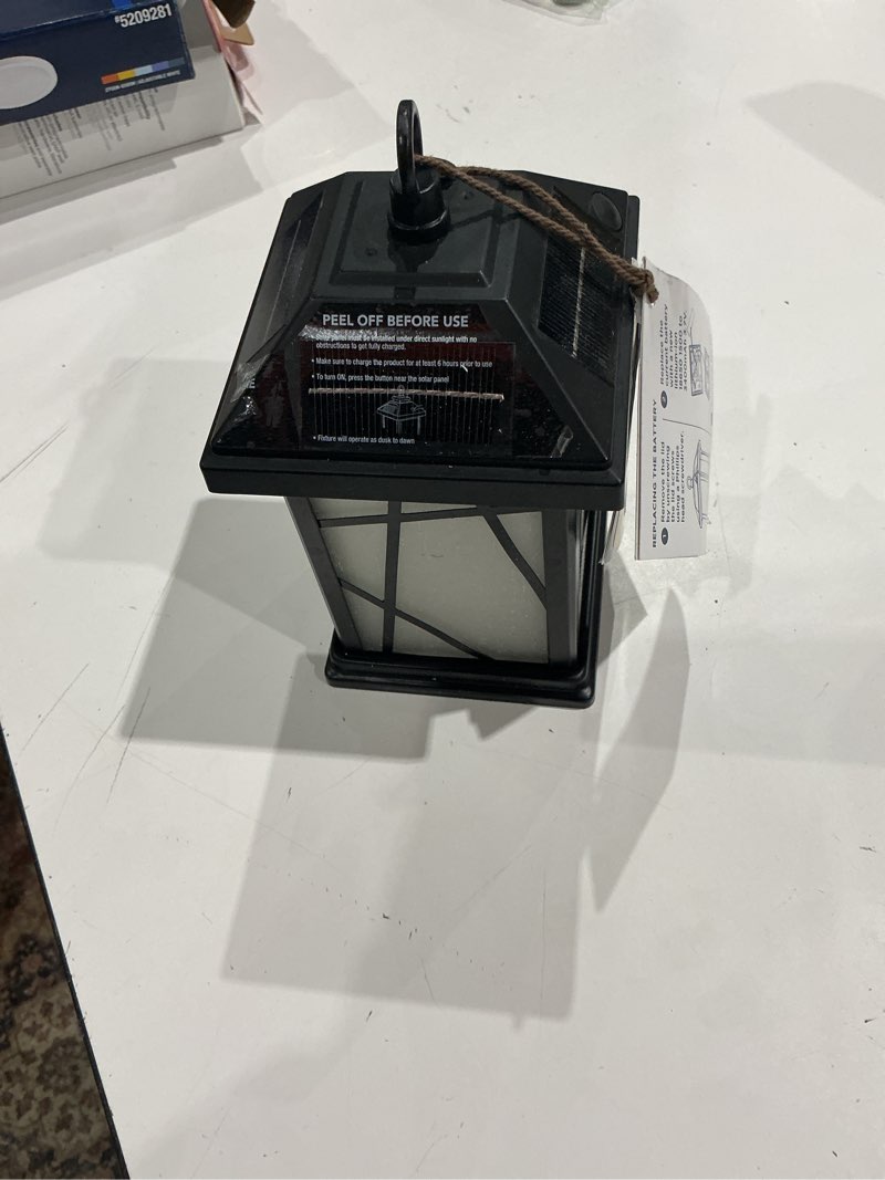 Condition photo showing As Is for harbor breeze flicker flame 10 -lumens black solar led outdoor path light with dusk-to-dawn...