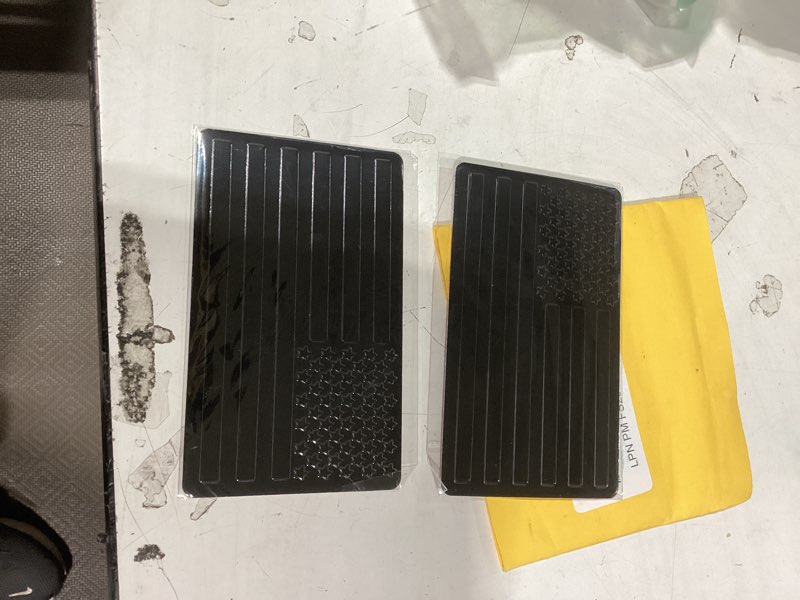 Condition photo showing New/Like New for embossed 3d metal all black american flag emblem decal stickers (1 pair), matte black 5" x 3" patriotic usa us flag car decals bumper stickers for truck, window, motorcycle, support us military black 1 pair 5" x 3"