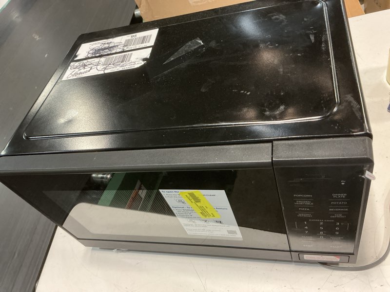 Condition photo showing As Is for mainstays 1.1 cu ft microwave oven in black