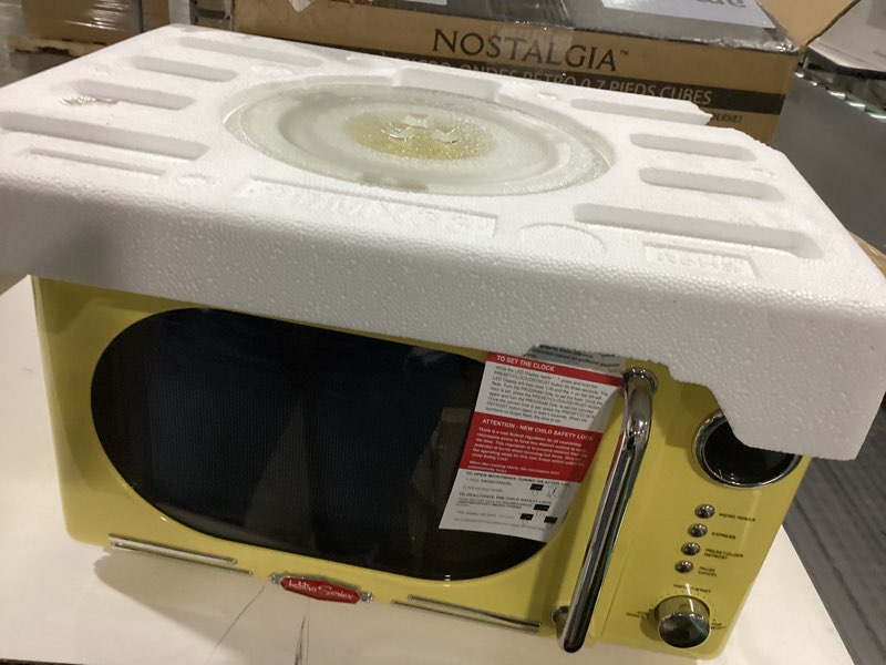 Condition photo showing Good Condition for Nostalgia NRMO7YW6A Retro Compact Countertop Microwave Oven, 0.7 Cu. Ft. 700-Watts with LED Digital Display, Child Lock, Easy Clean Interior, Yellow Retro Classic 0.7 Cu. Ft. Yellow
