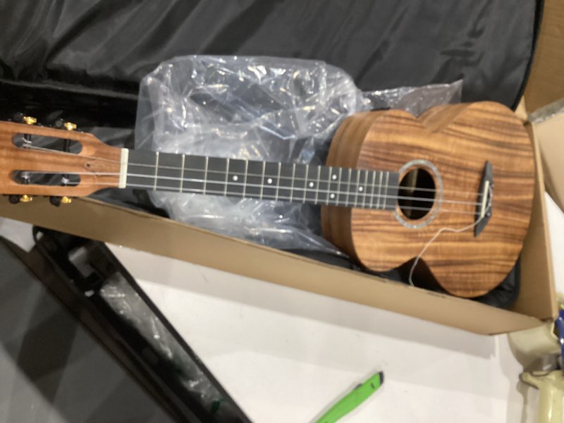 Condition photo showing As Is for left handed - caramel blm27 acacia baritone acoustic & electric ukulele