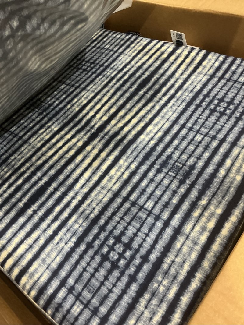 Condition photo showing Good Condition for arden outdoor foam deep seat cushion set (2-pack), 24x24, premium high-density foam, never flattens, weather-proof for patio chair sofa couch, blue shibori stripe certi-pur foam blue shibori stripe 2 pack