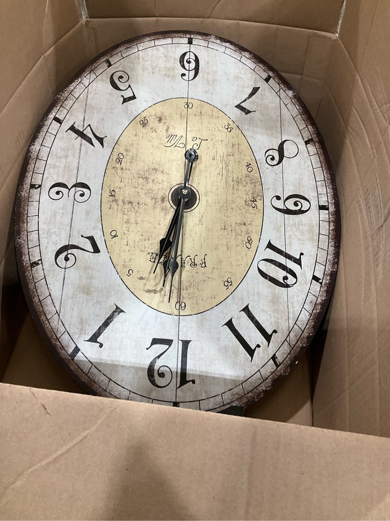 Condition photo showing As Is for MODE HOME Large French Country Oval Wall Clock for Living Room Decor, 18 x 29 Inch Rustic Farmhouse Wall Clock Decorative, Solid Wood Frame with Iron Hanging Ring, Silent Non-Ticking Battery Operated 29 Inch Oval Wall Clock