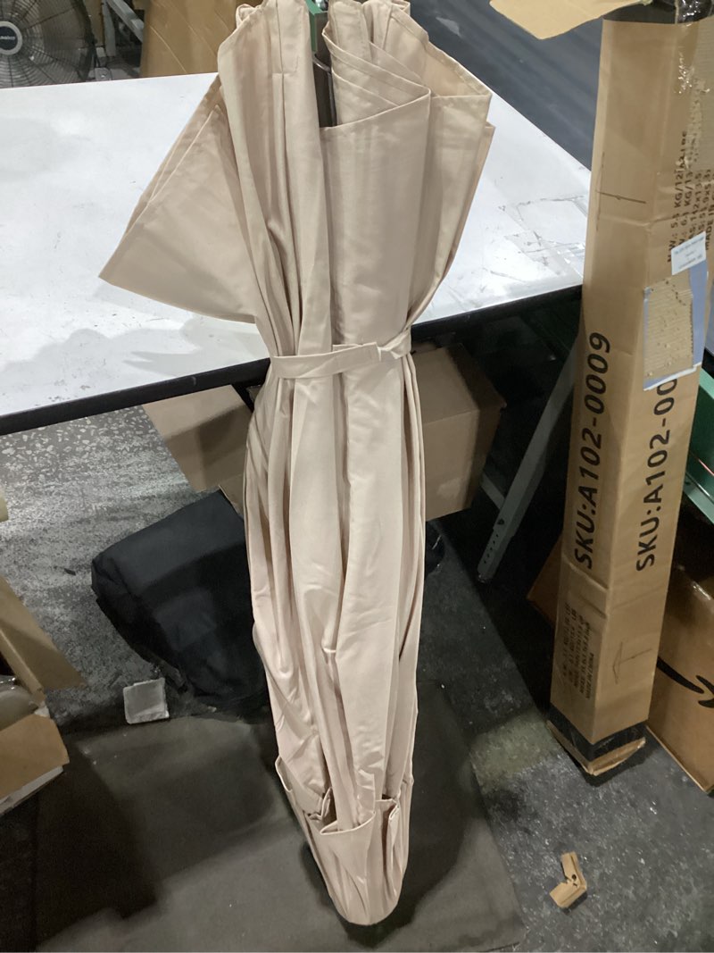 Condition photo showing Good Condition for ayge 9ft large outdoor patio umbrella market table umbrella-uv resistant, easy push button tilt and crank, 8 sturdy fiberglass ribs heavy-duty pool umbrella for deck, backyard,garden,beige