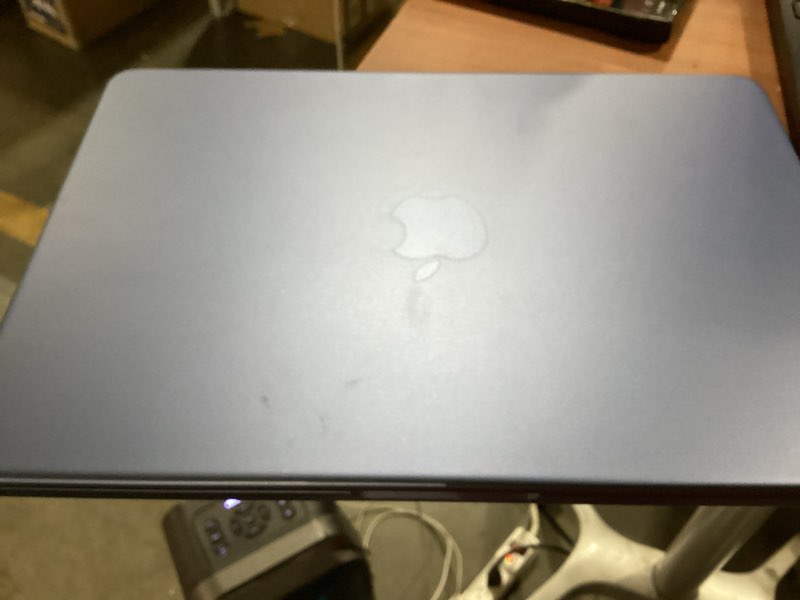 Condition photo showing As Is for macbook neo 8gb memory 13” 512gb storage (no power cord) and missing one key 