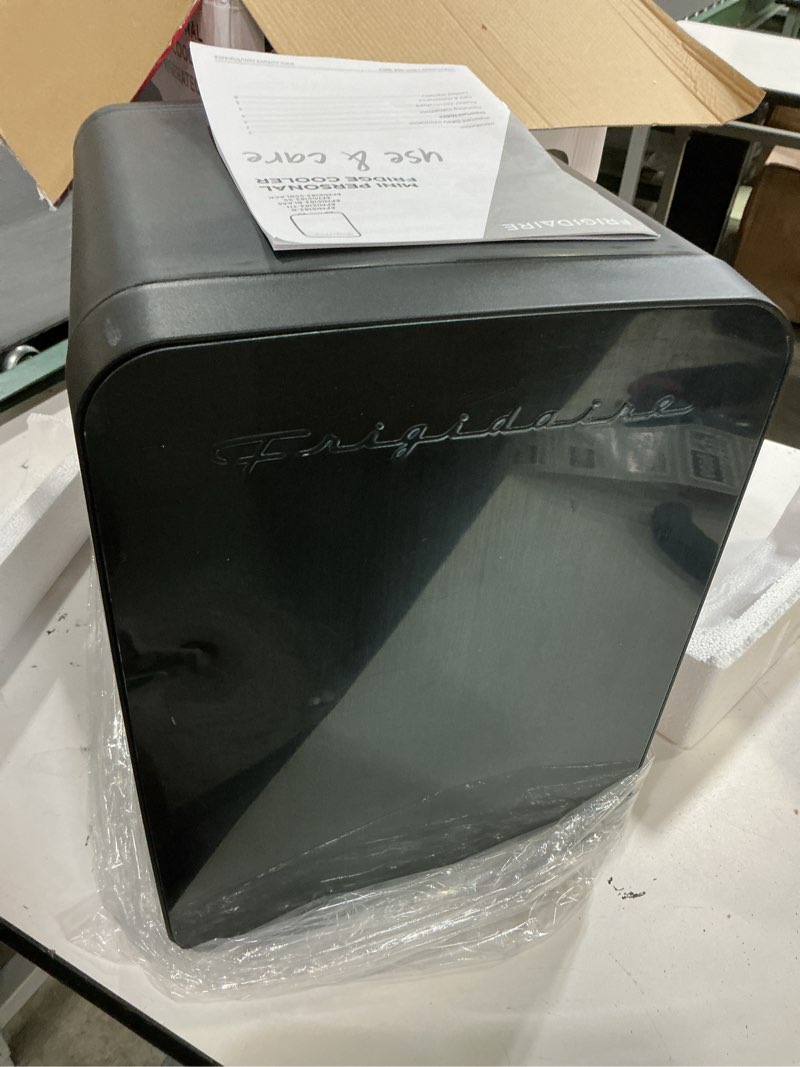 Condition photo showing Good Condition for frigidaire mini personal fridge cooler, countertop, holds up to 10l/15 cans, brushed black stainless rugged design, portable for skincare, makeup, car, office, bedroom, dorm room, or cabin