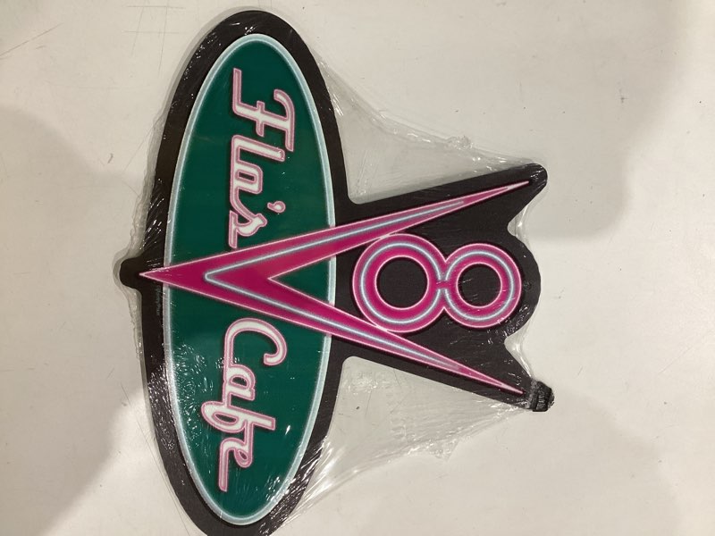 Condition photo showing As Is for Disney Pixar Cars Flo's V8 Cafe Metal Wall Sign - Fun Cars Diner Decoration for Home Pink/Green