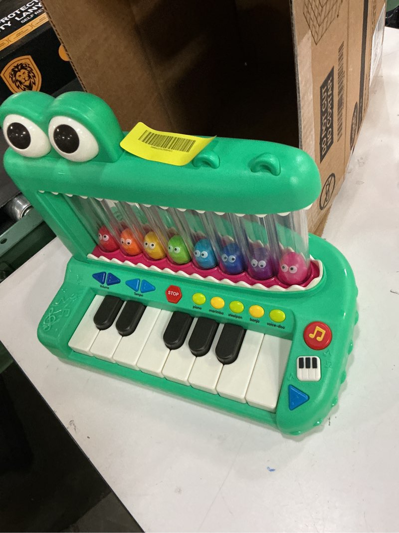 Condition photo showing As Is for battat croco pop piano toy keyboard with songs sounds lights, baby and toddler toys
