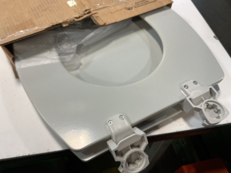 Condition photo showing As Is for bemis 1500ec durable wood toilet seat with easy clean hinges, made in usa, elongated, ice grey elongated 1-pack elongated