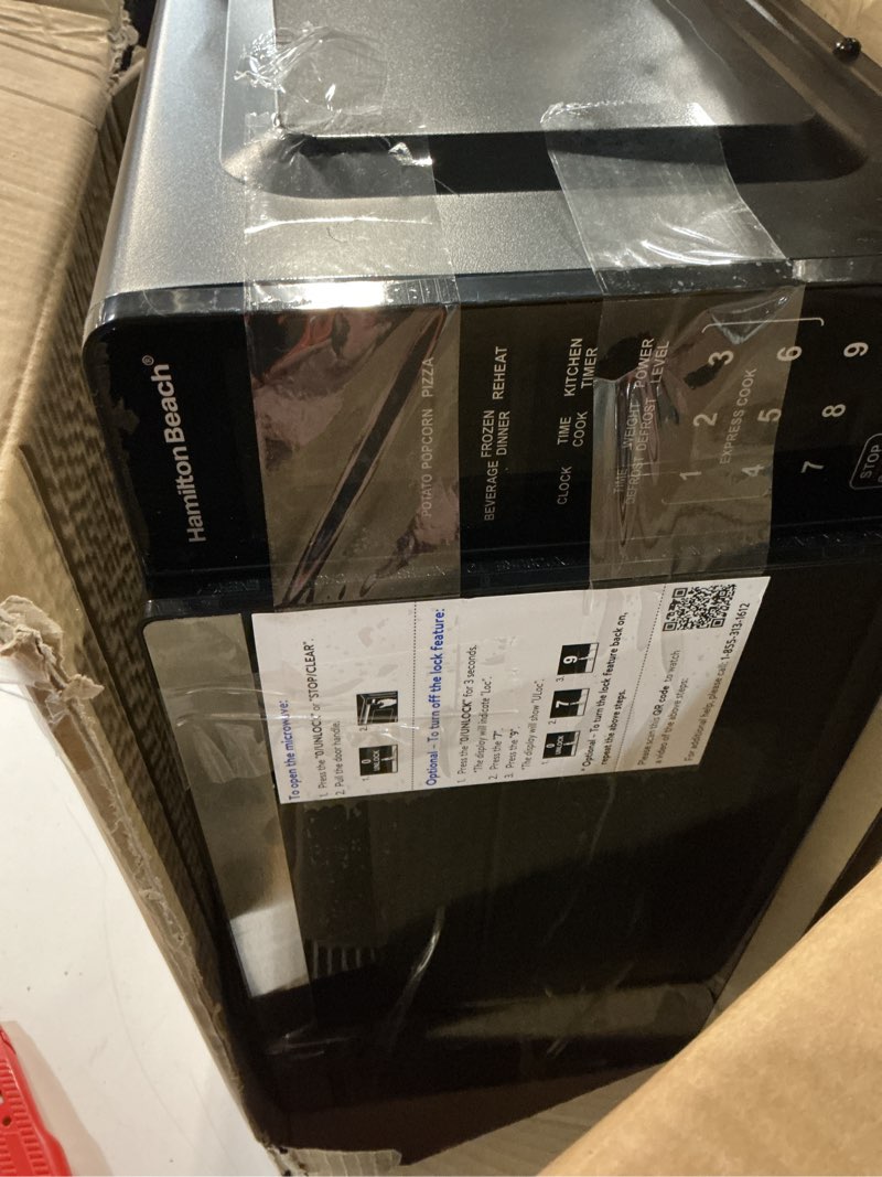 Condition photo showing As Is for hamiilton 0.9 cu ft countertop microwave oven, 900 watts, stainless steel