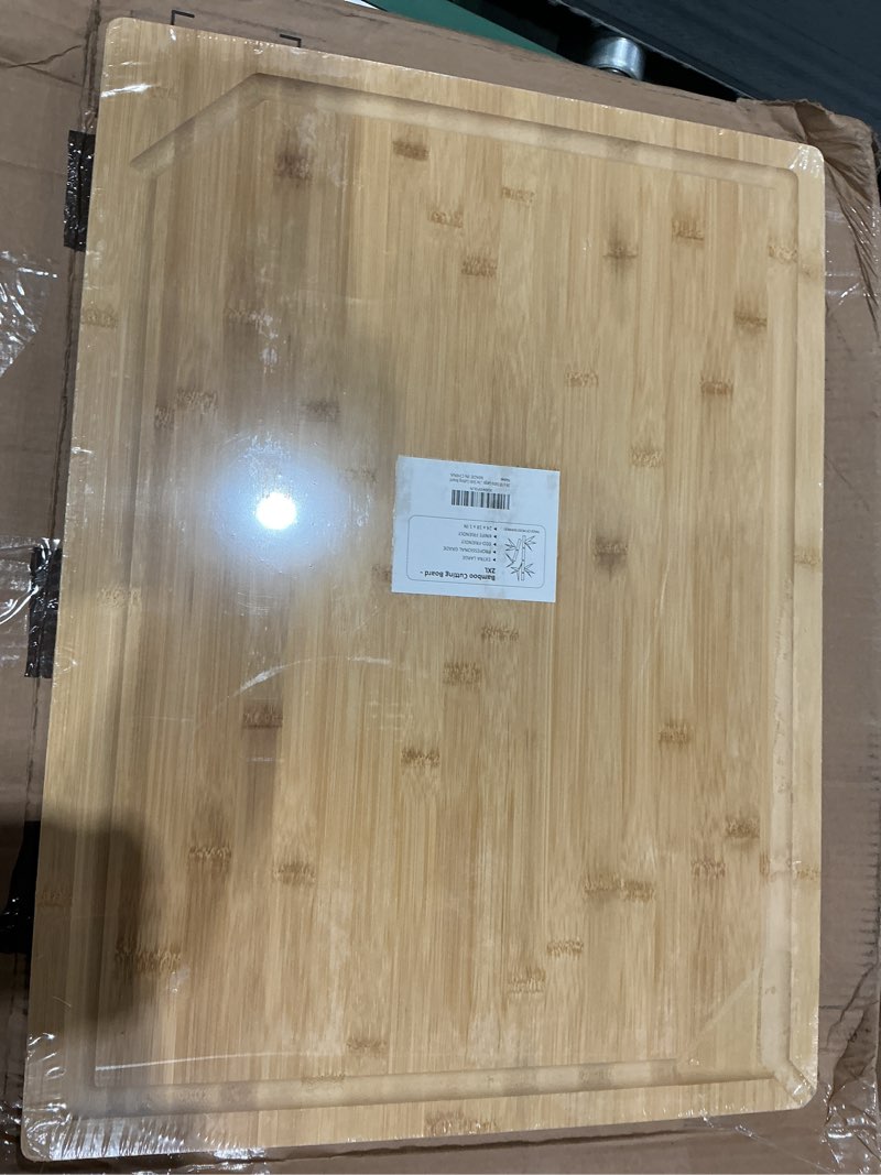 Condition photo showing New/Like New for 24 x 18 extra large bamboo serving boards for kitchen, heavy duty wood butcher block chopping board with handle and juice groove for meat, large charcuterie board, over the sink cutting board natural bamboo 24"l x 18"w | single board