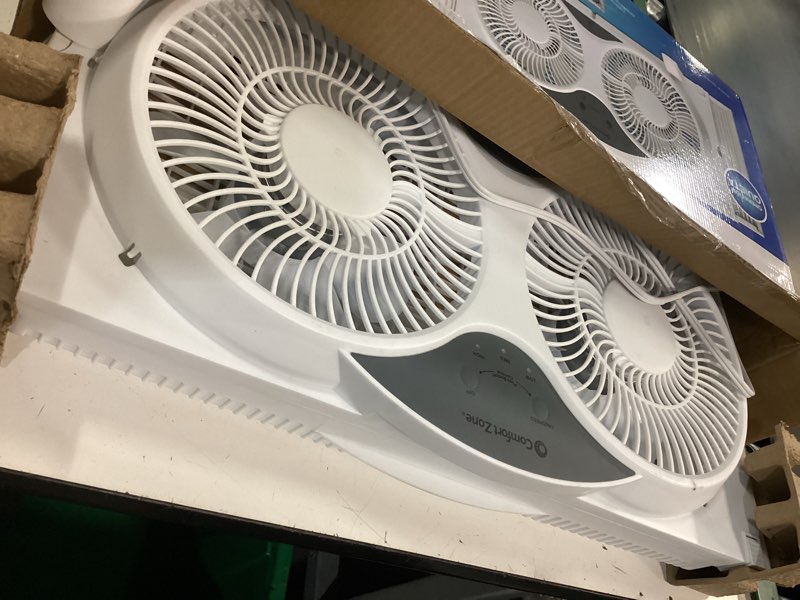 Condition photo showing As Is for comfort zone window fan for bedroom, 9 inch 3 speed dual fans with auto-locking expanders, 3 modes (cool, circulate, exhaust), remote control, fabric cover plus bug screen, white white 9" twin window fan w/ remote