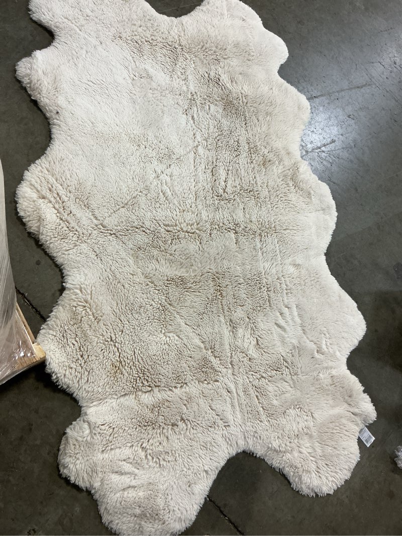 Condition photo showing As Is for mon chateau faux fur quad rug  ivory 3ftx6ft