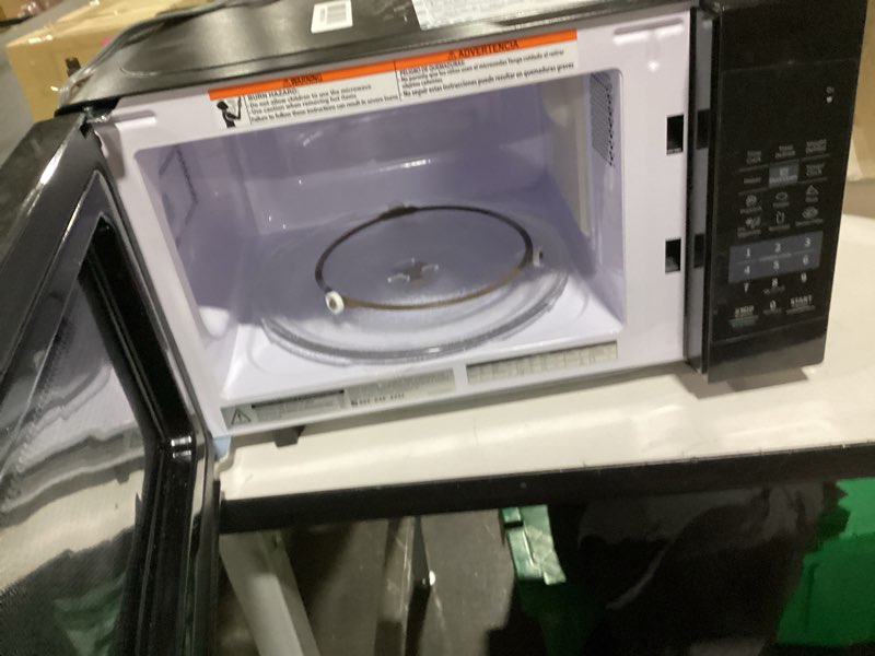 Condition photo showing As Is for COMFEE' EM720CPL-PMB Countertop Microwave Oven with Sound On/Off, ECO Mode and Easy One-Touch Buttons, 0.7cu.ft, 700W, Black 0.7 Cu.Ft Black