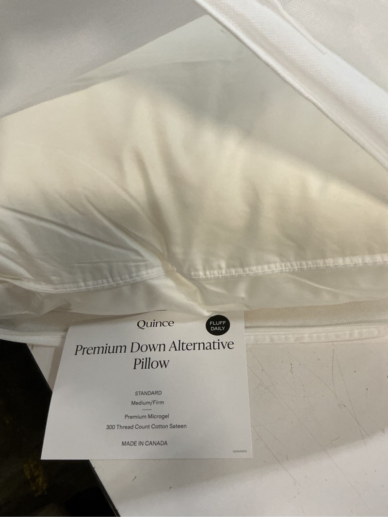 Condition photo showing As Is for premium down alternative pillow standard medium/firm 