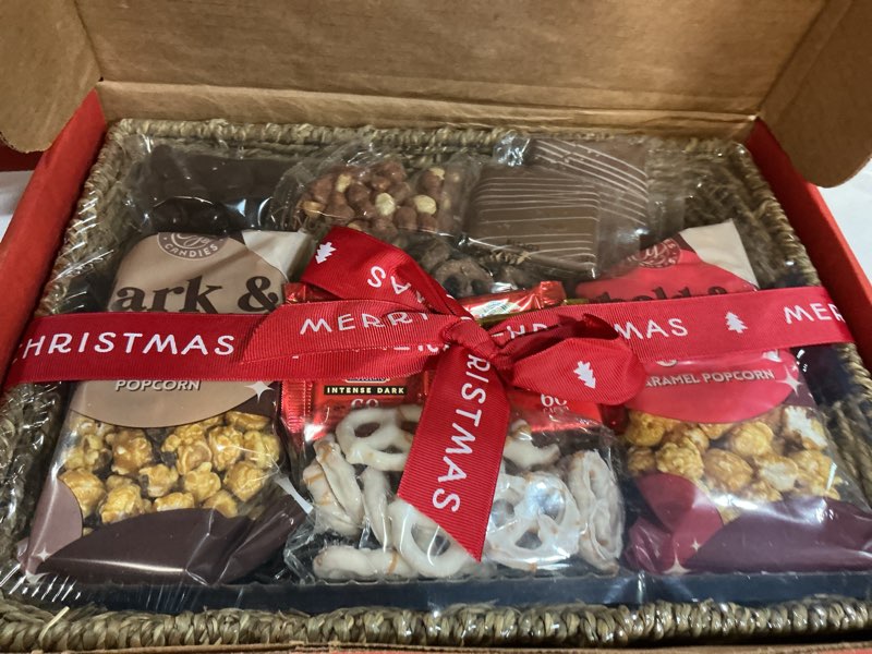 Condition photo showing New/Like New for a gift inside merry christmas chocolate caramel and crunch grand gift basket( bb09/25/26)