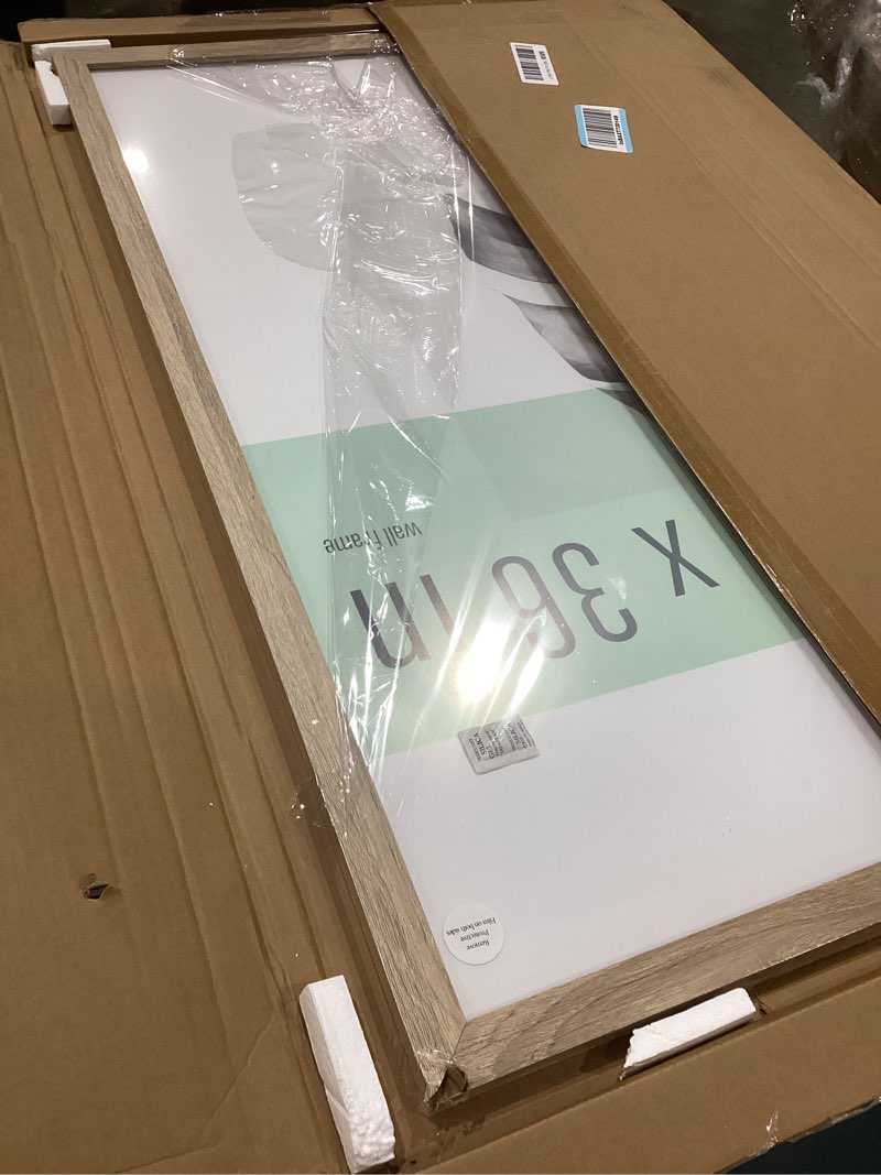 Condition photo showing As Is for mcs studio gallery 24x36 poster frame natural woodgrain engineered wood, vertical & horizontal wall hanging large picture frame for photos, posters & art prints (1-pack) 1-pack natural woodgrain 24x36