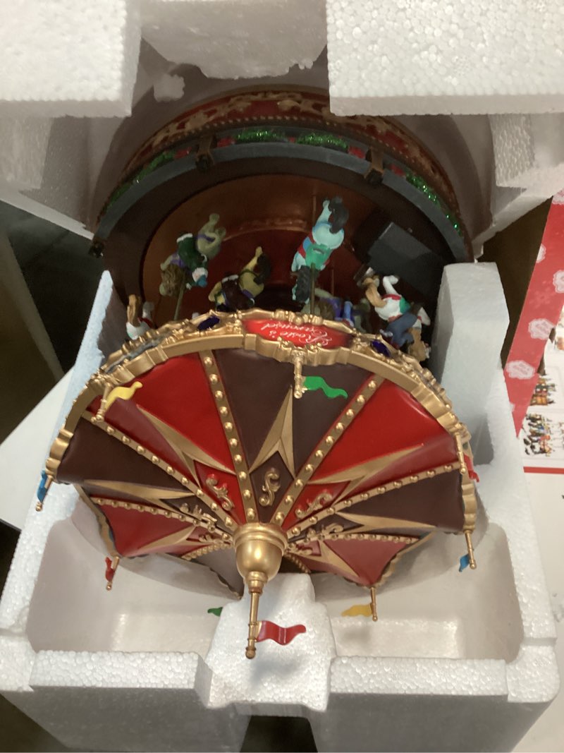 Condition photo showing Good Condition for MOMENTS IN TIME Animated Rosie’s Carousel (Moving Carousel) 15.2“H LED Lights 8 Classic Carols Christmas Music, Adapter Included Christmas Village Handcrafted Polyresin Moving Carouse