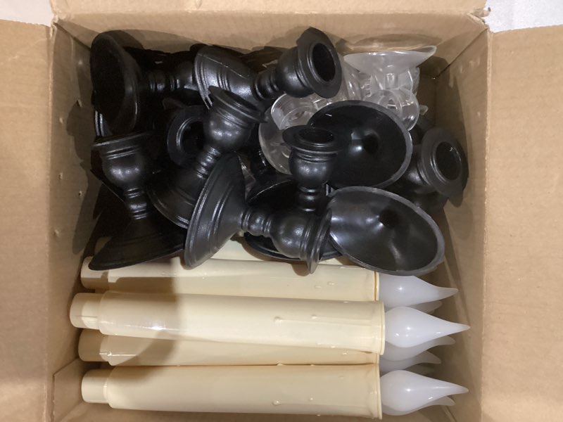Condition photo showing As Is for 12 pack battery operated window candles with sensor dusk to dawn, ivory flameless taper candlesticks with removable black base & suction cups, led candlestick for christmas decor home, 24 aa batteries