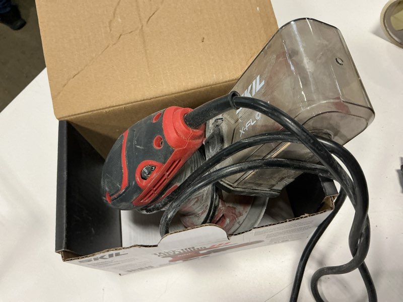 Condition photo showing As Is for skil 120 volts 2.8-amp variable random orbital corded sander with dust management