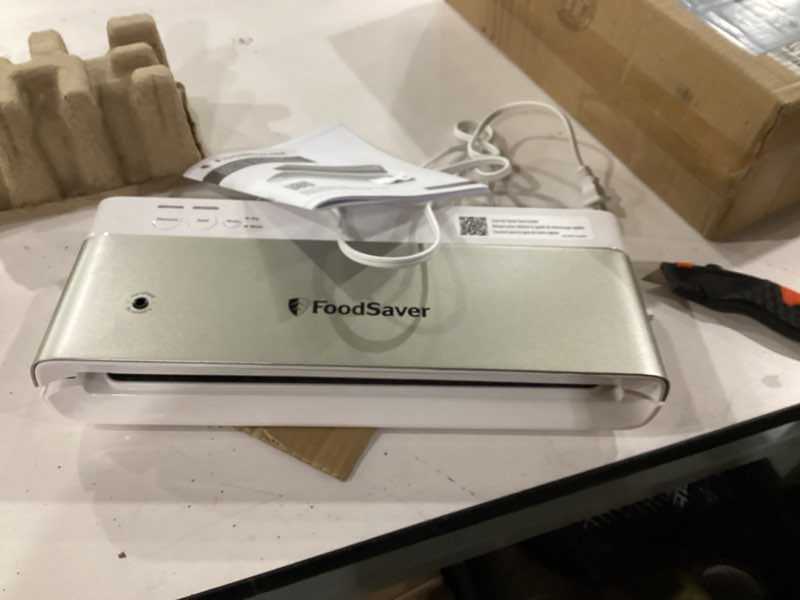 Condition photo showing As Is for FoodSaver Compact Vacuum Sealer Machine with Airtight Bags and Roll - Ideal for Sous Vide and Airtight Food Storage, White