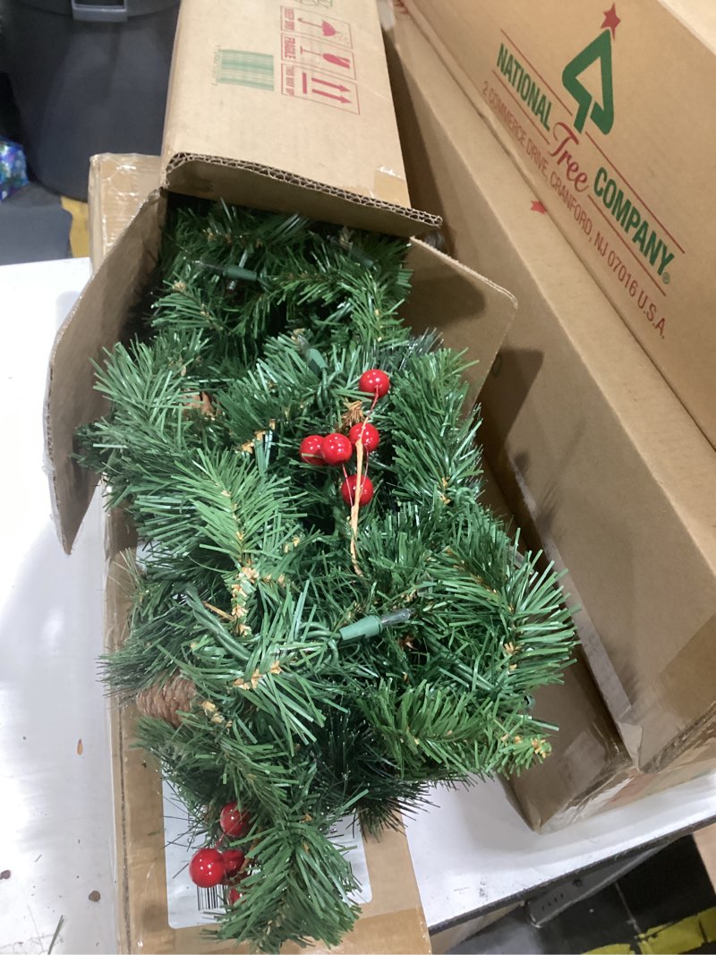 Condition photo showing New/Like New for national tree company 9 ft pre-lit crestwood spruce artificial christmas garland, christmas decoration with glitter, pinecones, red berries, 50 clear lights, 180 tips, green plug in tree