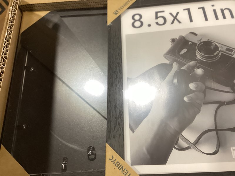 Condition photo showing Good Condition for 8.5 by 11 picture frame set of 3 - black woodgrain, hd tempered glass, certificates & awards, table display or wall hanging 3 pack black 8.5 x 11