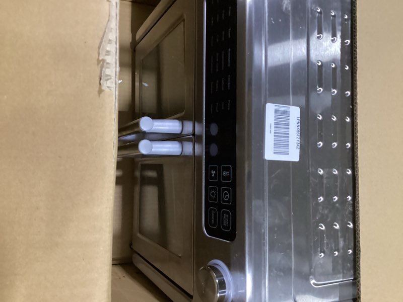 Condition photo showing New/Like New for dan - emeril lagasse extra large french door air fryer toaster oven combo, 24 cooking functions and digital controls, 7 accessories included, stainless steel finish, 26qt capacity