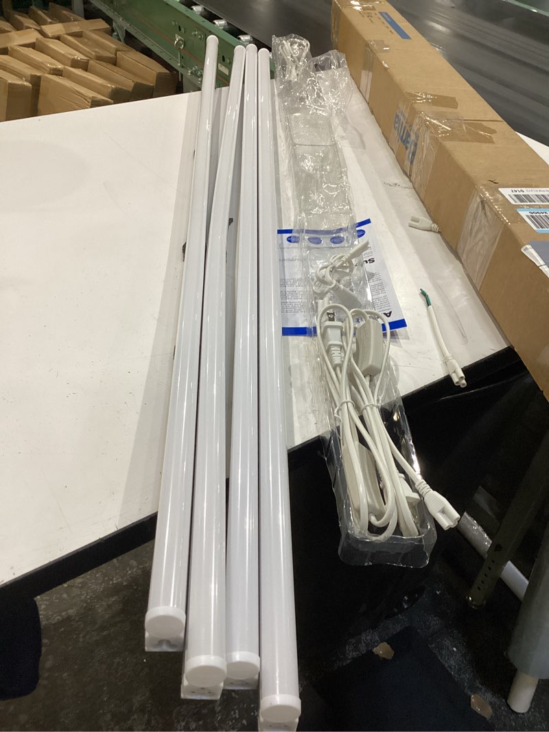 Condition photo showing As Is for barrina (4 pack led t5 integrated single fixture, 4ft, 2200lm, 6500k super bright white, 20w utility led shop light, ceiling and under cabinet light, corded electric with on/off switch, etl listed