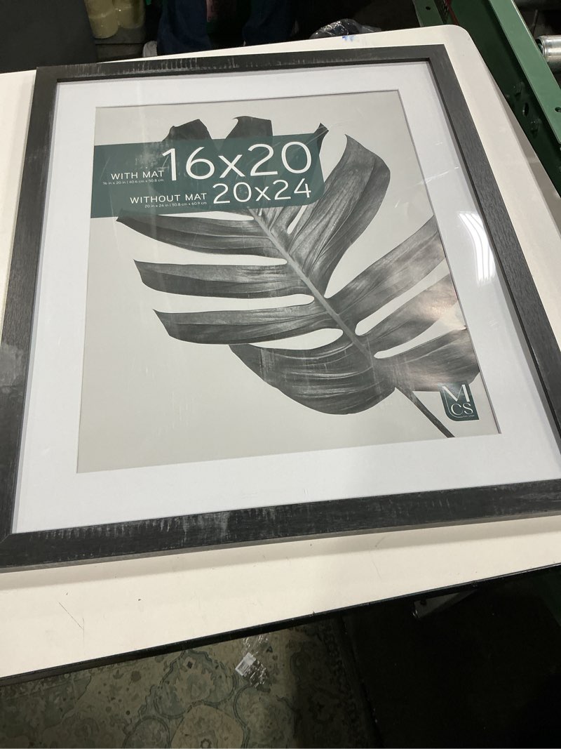 Condition photo showing Good Condition for mcs studio gallery 20x24 matted poster frame with 16x20 picture display, black woodgrain engineered wood vertical & horizontal wall hanging large picture frame for photos, posters & art prints (1-pack) 1-pack black woodgrain 20x24