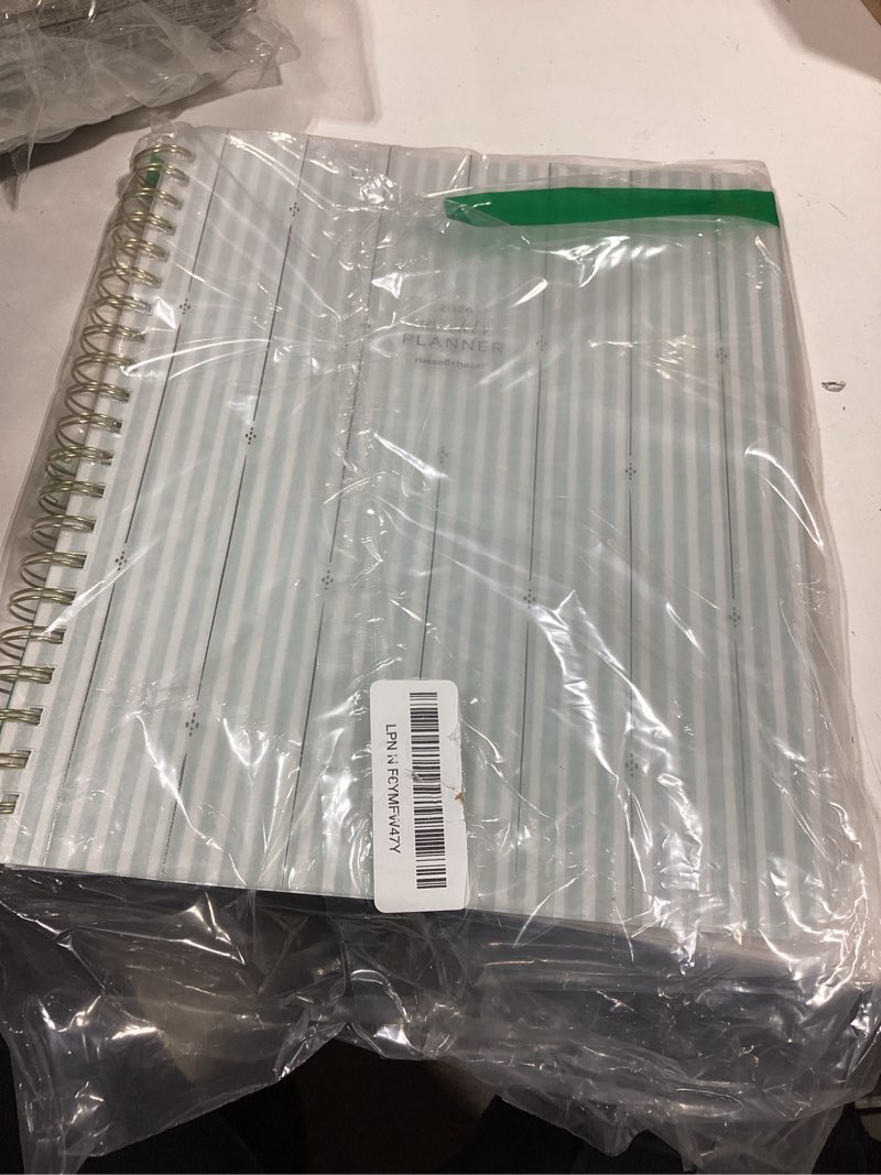 Condition photo showing As Is for russell+hazel 2026 weekly planner, pp stripe cover with gold foil details, 190 foil stickers, double sided pocket, 9.125” x 11.25”, 1-count (105865)