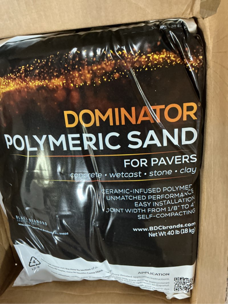 Condition photo showing New/Like New for 40 pound charcoal gray dominator polymeric sand with revolutionary ceramic flex technology for stabilizing paver joints/gaps, 1/8” up to 4”, professional grade results