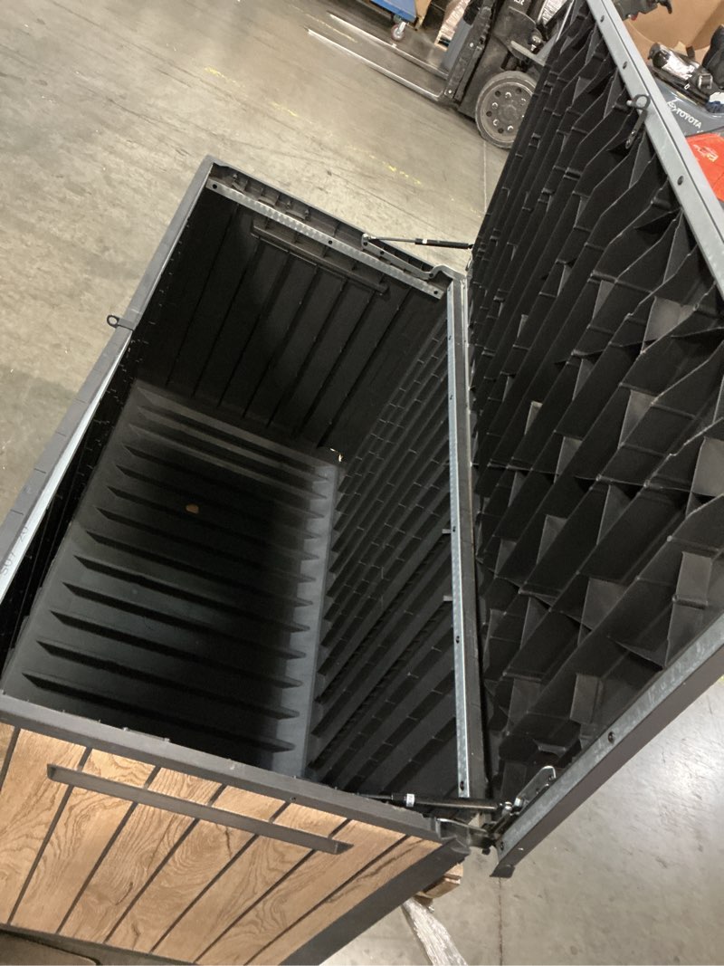 Condition photo showing As Is for keter signature collection 150 gallon resin deck box organization and storage box for patio outdoor cushions, throw pillows, garden tools and pool supplies, ashwood ashwood 150 gallon
