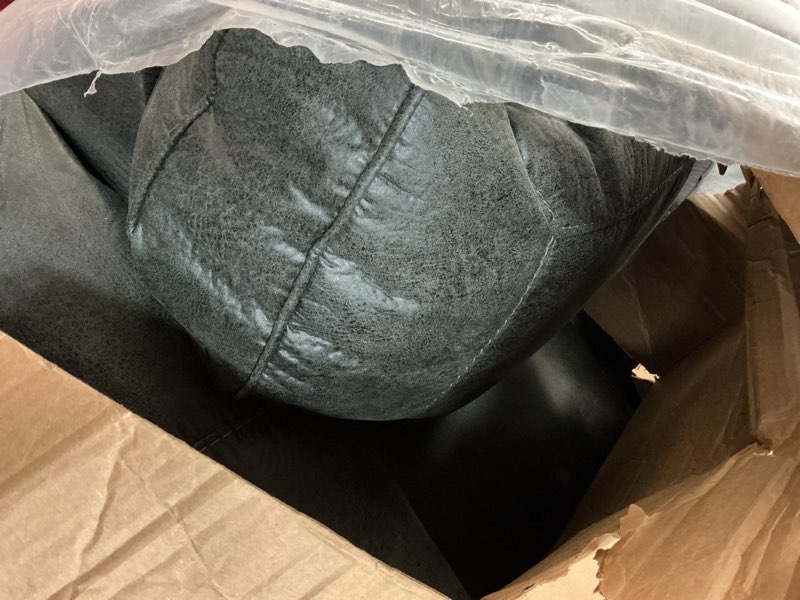 Condition photo showing As Is for Signature Design by Ashley dark grey sofa with nailhead trim 