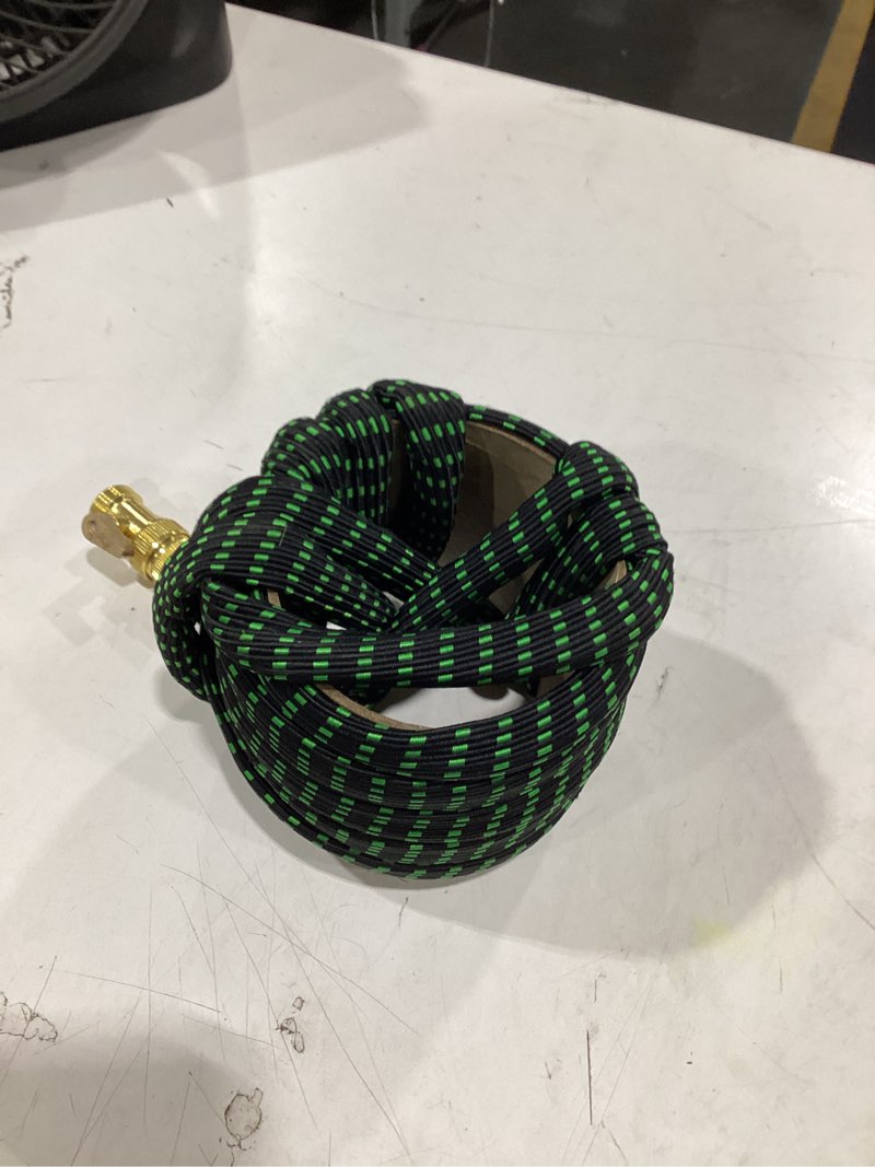 Condition photo showing As Is for this is a flexible, expandable garden hose featuring a black and green woven fabric exterior.