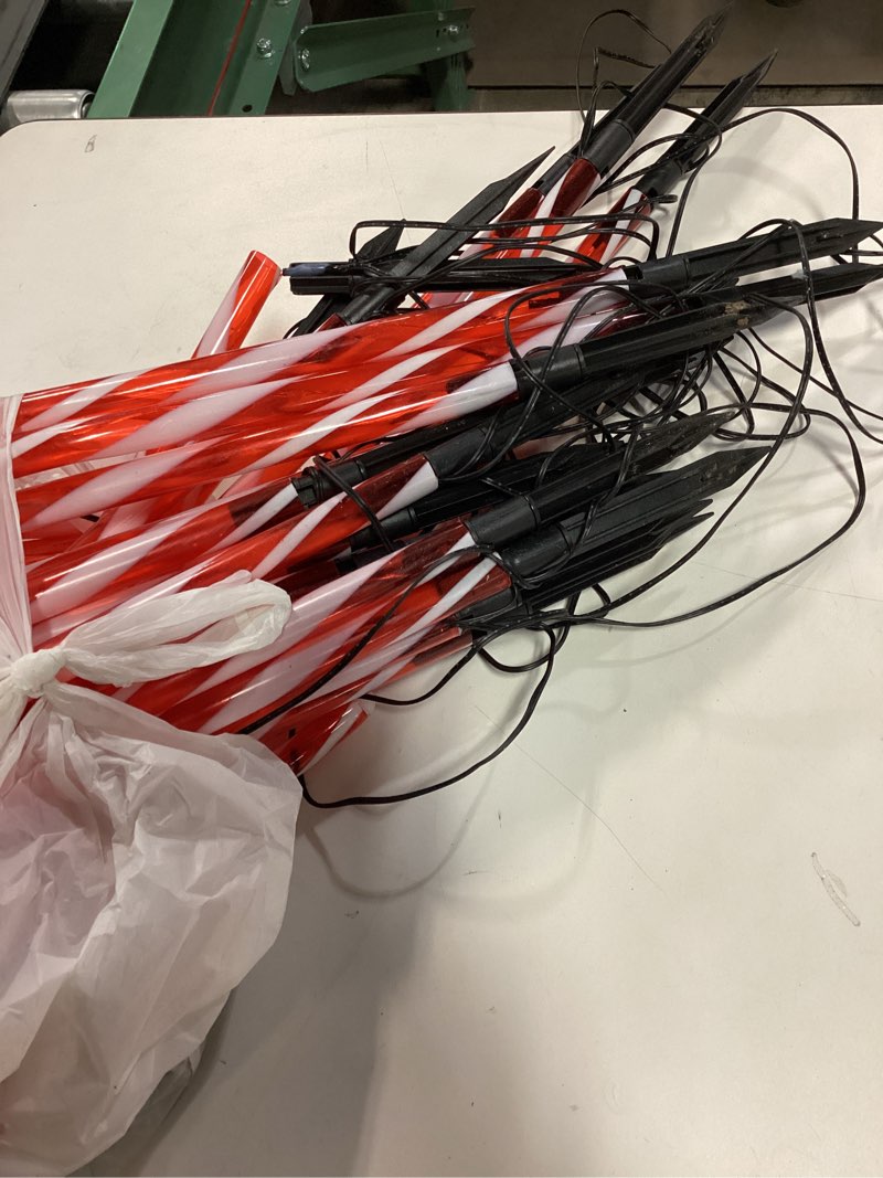 Condition photo showing As Is for Upgraded 24 Pack Candy Cane Solar Christmas Lights Waterproof, Rechargeable Pathway Lights with Remote, Solar Powered & USB Charging Christmas Decorations Outdoor for Garden Lawn Yard Party Warm White 24 Pack(Solar)