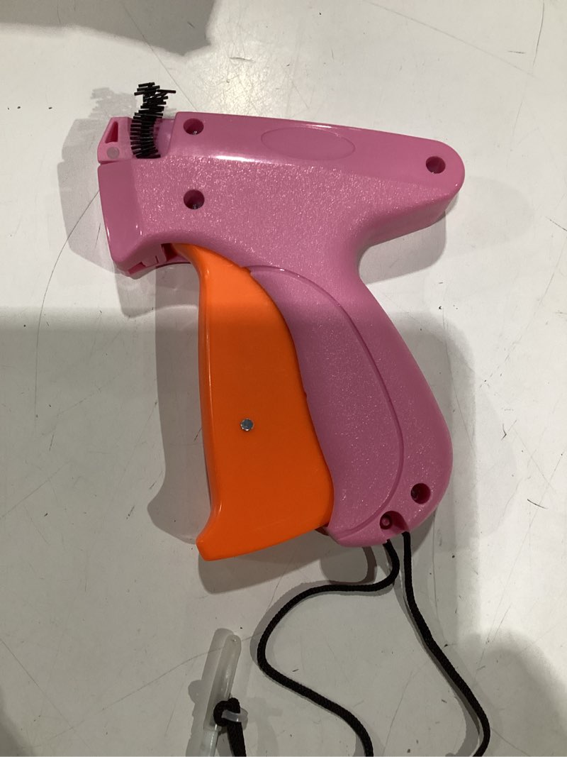 Condition photo showing As Is for stitch gun for clothes - handheld stitch gun quick clothing fixer - tagging gun - includes 6 needle, 1000 black fasteners & 1000 white fasteners pink,orange