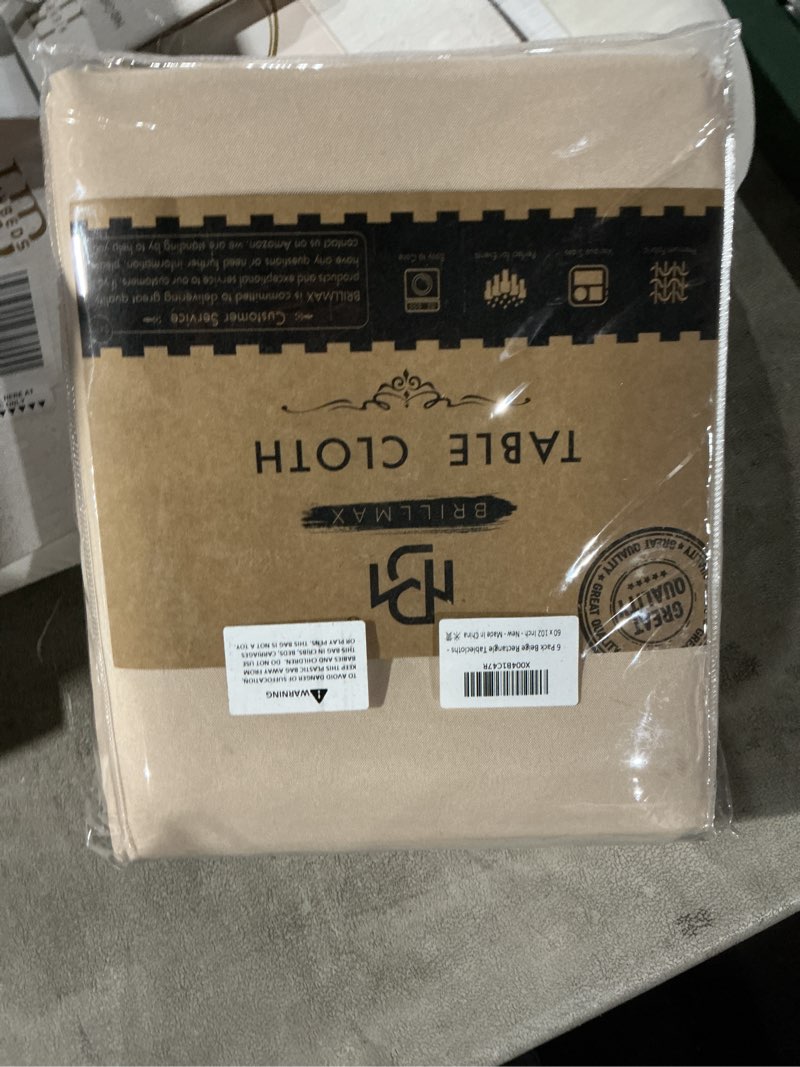 Condition photo showing Good Condition for BRILLMAX 6 Pack Beige Tablecloths for 6 Foot Rectangle Tables 60 x 102 Inch - 6ft Rectangular Bulk Linen Polyester Fabric Washable Cloth Cover for Wedding Reception Banquet Birthday Party Beige 60x102 In, 6 Pack