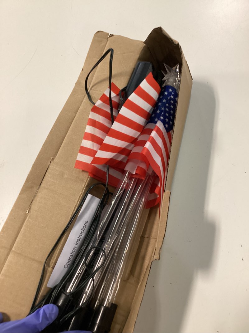 Condition photo showing As Is for 4th of july decorations outdoor american flag lights, 6-pack red white and blue solar stars lights with 6 usa flags & 30led,bright patriotic pathway lights for memorial day yard lawn decor