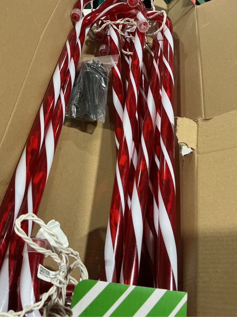 Condition photo showing As Is for 26" Christmas Candy Cane Pathway Markers Lights,18Ft Total Lenghth with 100 Lights, 10 Pack 26 Inch Candy Cane Lights(Red-White) for Christmas Decorations Red 26 inch