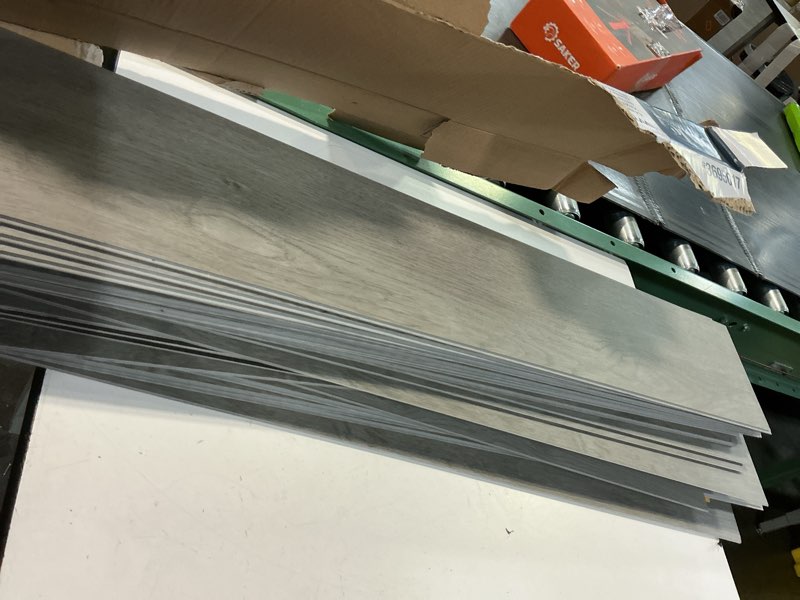 Condition photo showing As Is for style selections slate oak gray 6-mil x 6-in w x 36-in l waterproof interlocking luxury vinyl plank flooring (22.17-sq ft/ carton)