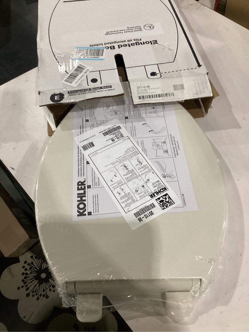 Condition photo showing As Is for kohler 20110-96 brevia, slow close toilet seat, elongated toilet seat, grip-tight bumpers quick-attach hardware, biscuit biscuit elongated quiet-close