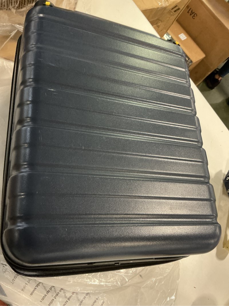 Condition photo showing As Is for Amazon Basics 21" Hardside Carry-On Luggage, Hardshell Suitcase With Wheels, Expandable For Up to 25% More Space, With Scratch-Resistant Surface, Four Multi-directional Wheels, Navy Blue Navy Blue Carry-On