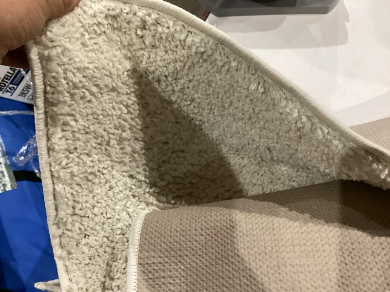 Condition photo showing As Is for modera 5 ft. x 8 ft. white solid color area rug