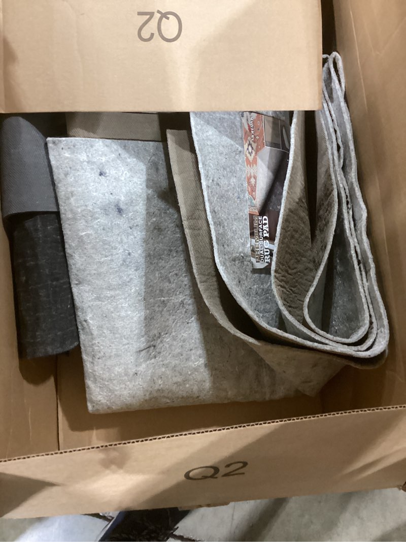 Condition photo showing As Is for Mohawk Home 8' x 10' Non Slip Rug Pad Gripper 1/4 Thick Dual Surface Felt + Rubber Gripper - Safe for All Floors, Brown