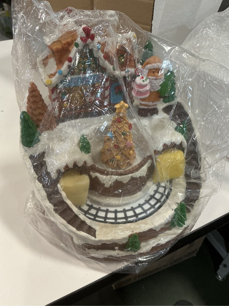 Condition photo showing Good Condition for DREAM GARDEN Christmas Village House, Gingerbread House with Moving Train and Christmas Tree Battery Operated Musical Collectible Buildings with LED Lights for Home Table Holiday Display Gingerbread House and Train